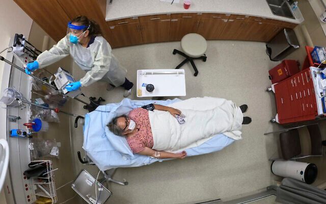 Illustrative image: a woman receives an antibody infusion while lying on a bed in a trauma room at the Upper Tanana Health Center Wednesday, Sept. 22, 2021, in Tok, Alaska. (AP Photo/Rick Bowmer)