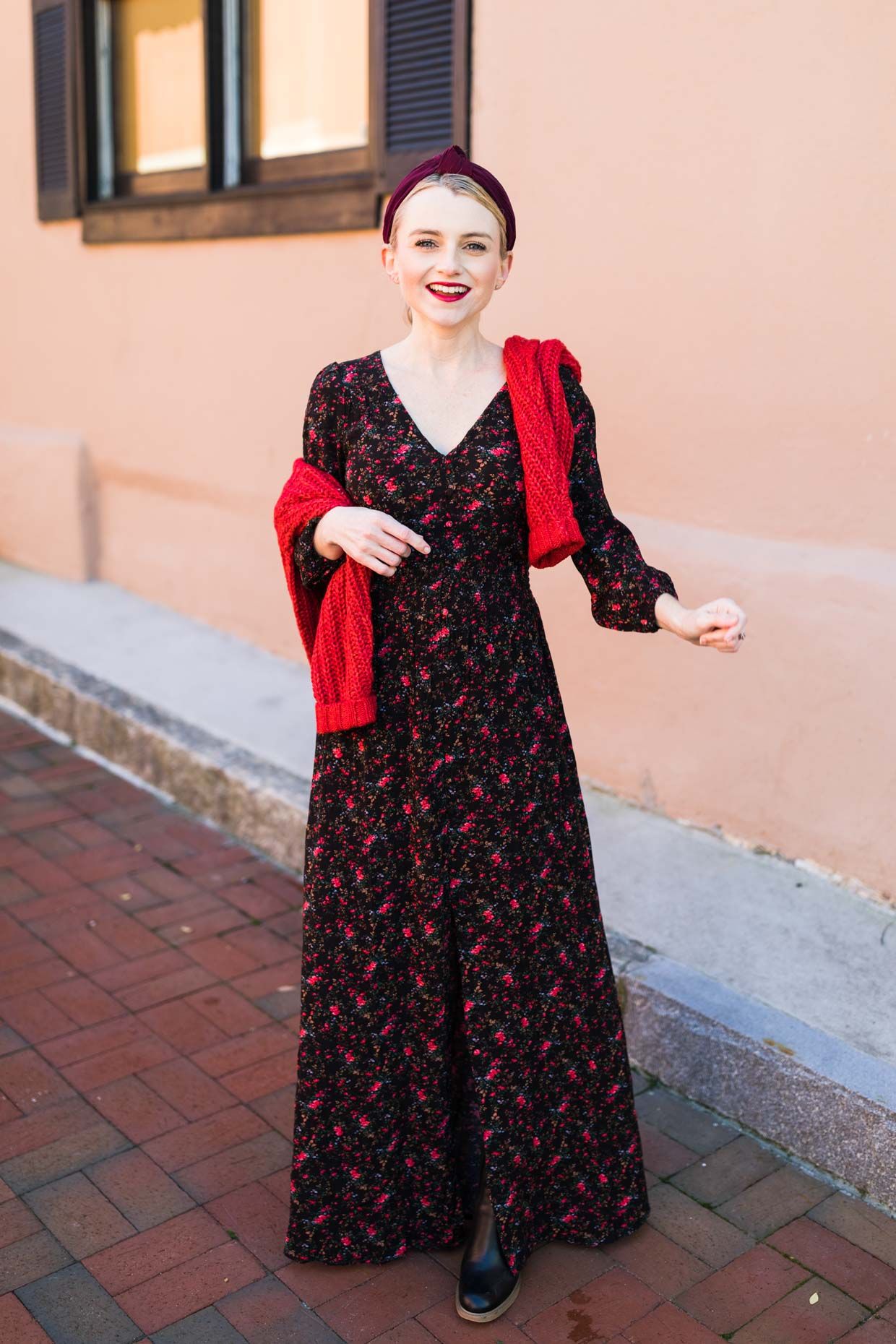 How To Style A Maxi Dress For Fall, tips featured by top US petite fashion blog, Poor Little It Girl: image of a woman wearing an American Eagle floral maxi dress, American Eagle red sweater, H&M headband, and Marc Fisher boots.