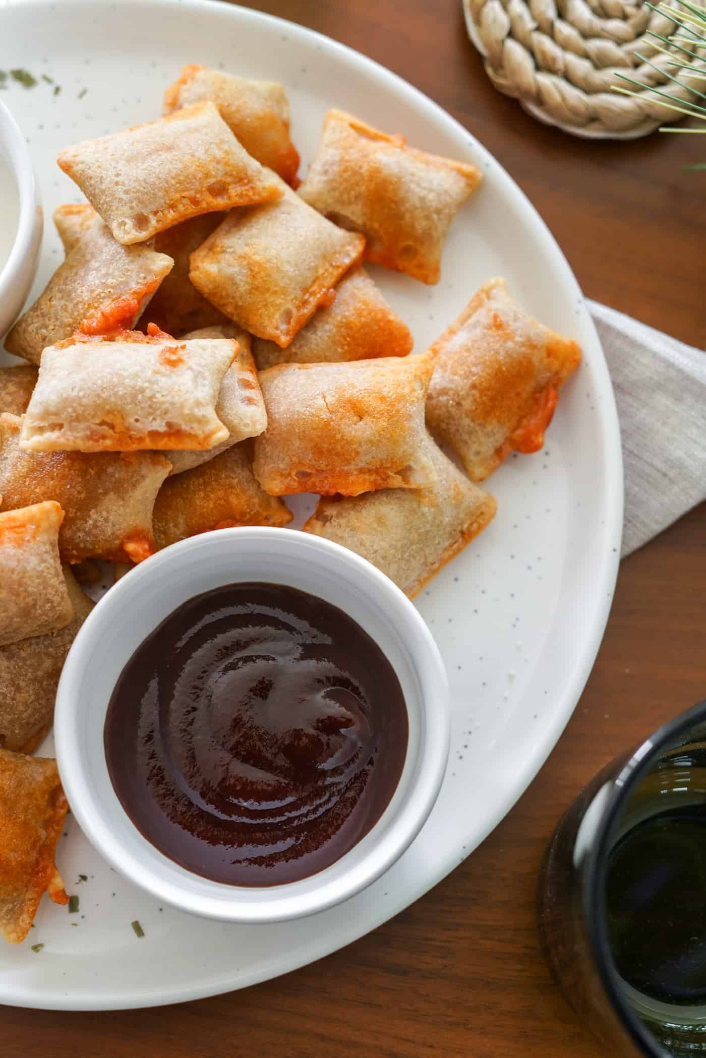air fryer pizza rolls A plate of air fryer pizza rolls with barbecue dipping sauce