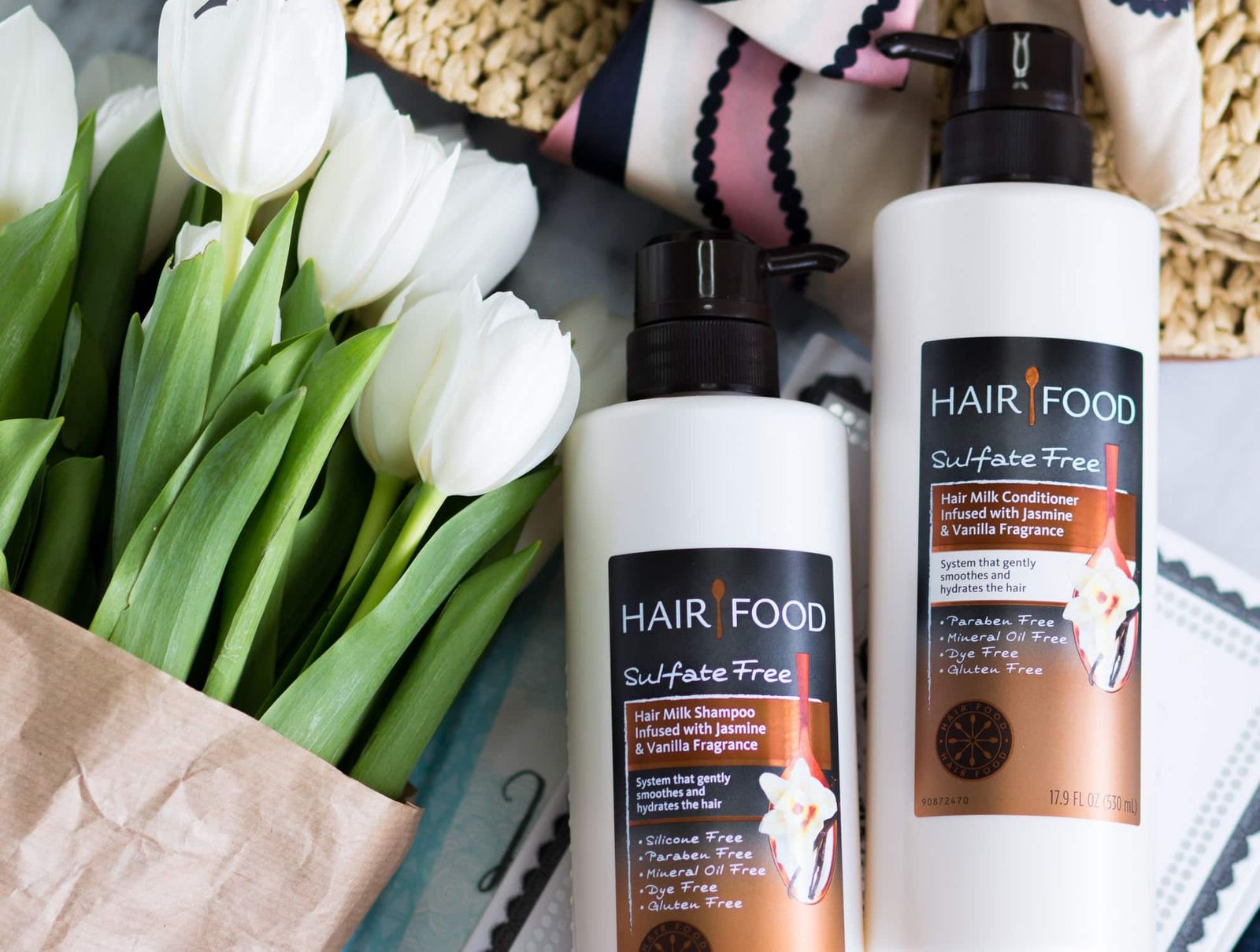 Moisturizing hair care favorites | Hair Food Hair Milk Sulfate-Free Shampoo and Conditioner Review | Why you should use sulfate-free hair products | Cute straw clutch with pink, navy, and cream scarf and white tulips | Affordable drugstore hair care favorites | Best of drugstore beauty | Beauty blogger Ashley Brooke Nicholas