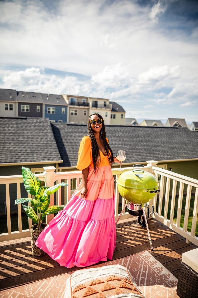 Staud Meadow Colorblock Maxi Dress | Social Distancing Mindset by popular D.C. lifestyle blogger, Alicia Tenise: image of a woman standing outside on her deck next to a Target Royal Stripe Outdoor Rug and wearing a Neiman Marcus Staud Meadow Colorblock Dress and Revolve Karen Walker Number One sunglasses.