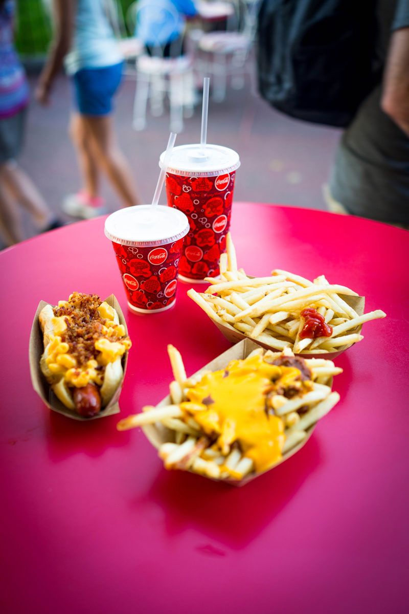 Mac n Cheese Hot Dog at DIsney's Magic Kingdom - Disney World For Adults by popular DC travel blogger Alicia Tenise