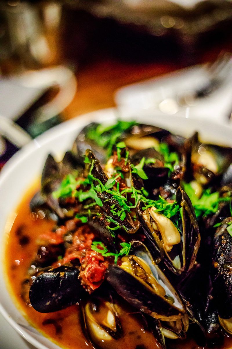 Top Things to Do in Charlottesville VA: a Complete Travel Guide by popular DC travel blogger, Alicia Tenise | Things to Do in Charlottesville VA in the Winter by popular DC travel blogger, Alicia Tenise: image of a plateful of mussels.