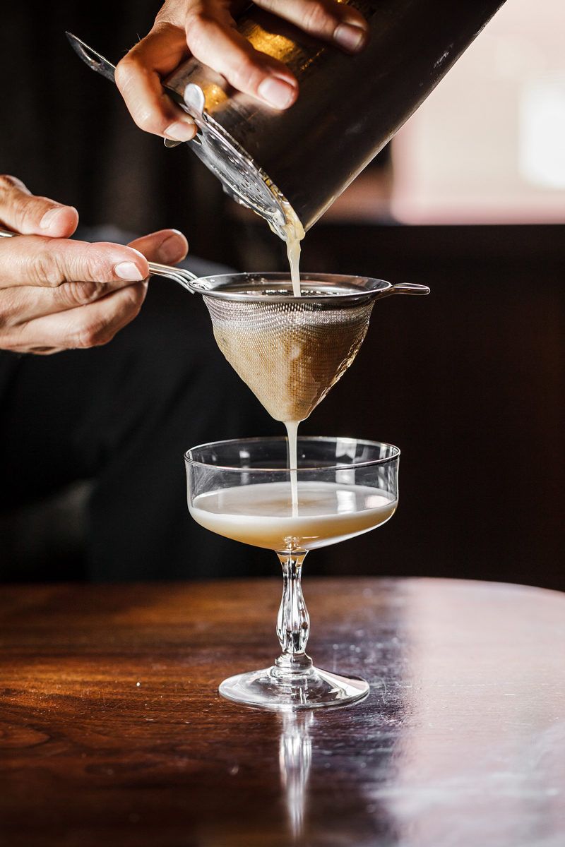 Top Things to Do in Charlottesville VA: a Complete Travel Guide by popular DC travel blogger, Alicia Tenise | Things to Do in Charlottesville VA in the Winter by popular DC travel blogger, Alicia Tenise: image of a cocktail being poured into a martini glass.