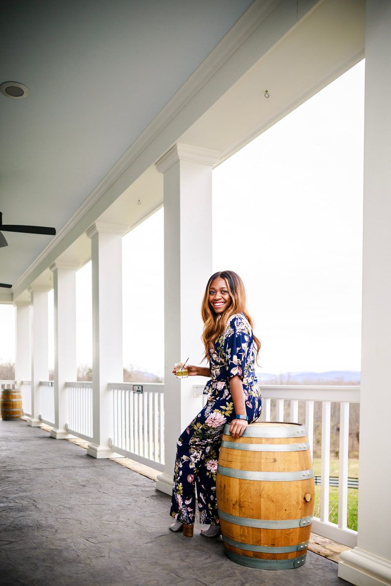 Top Things to Do in Charlottesville VA: a Complete Travel Guide by popular DC travel blogger, Alicia Tenise | Things to Do in Charlottesville VA in the Winter by popular DC travel blogger, Alicia Tenise: image of a woman at a Charlottesville Va distillery.