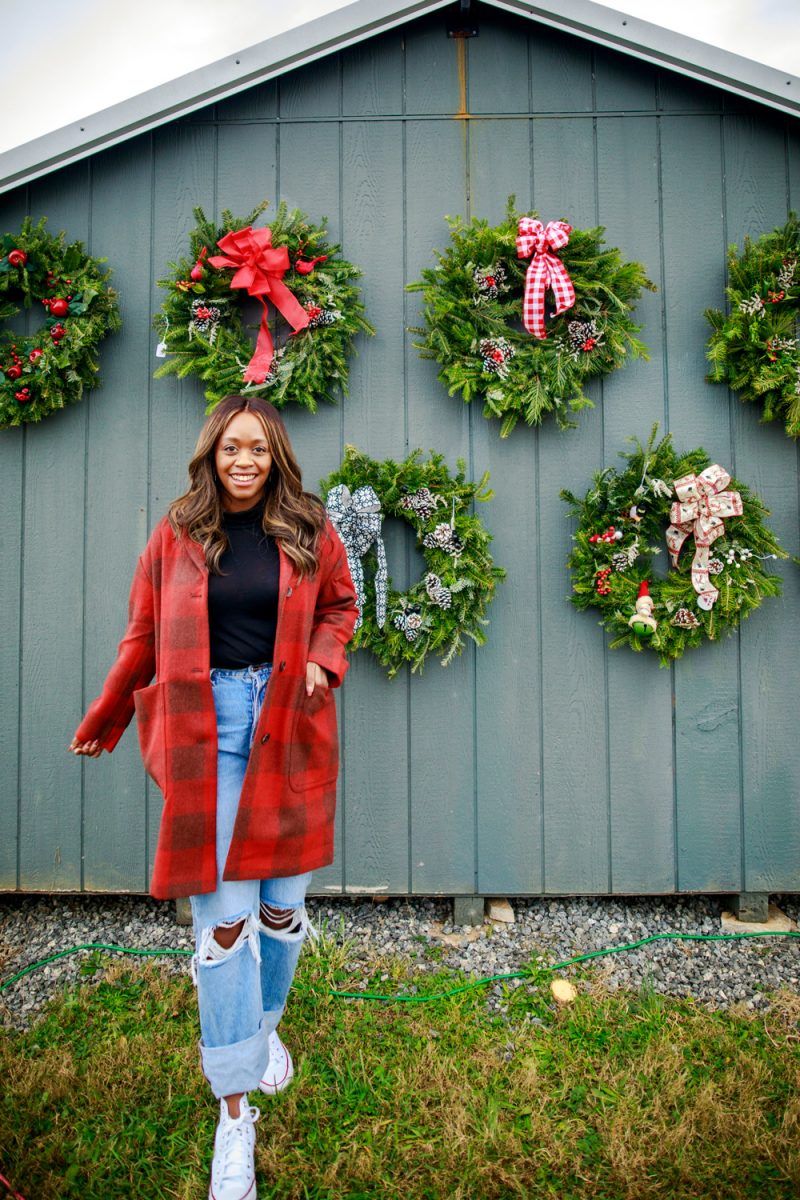 Plaid Coat from Walmart |Walmart Free Assembly by popular D.C. fashion blogger, Alicia Tenise: image of Alicia Tenise standing outside at a Christmas tree farm and wearing a Free Assembly red plaid cocoon coat, distressed denim, and black turtleneck shirt.