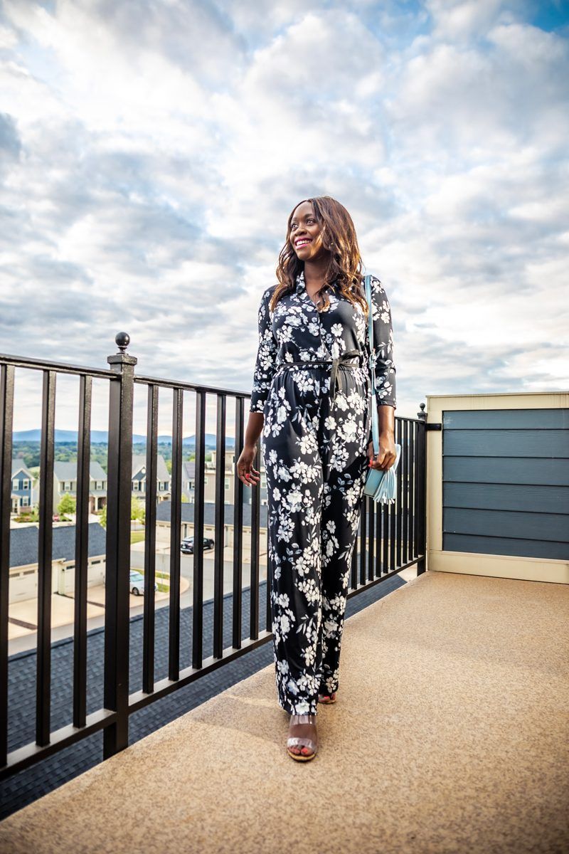 Calvin Klein Three-Quarter Floral Tie Waist Jumpsuit | Summer to Fall Looks: Two Transitional Outfit Ideas Under $100 by popular Washington D.C. fashion blogger, Alicia Tenise: image of a woman standing outside and wearing a Walmart Calvin Klein Three-Quarter Floral Tie Waist Jumpsuit and Metallic Sky Circle Crossbody.