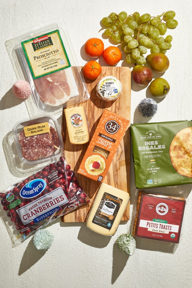 Holiday Cheese Board Ingredients |Charcuterie Board by popular D.C. lifestyle blogger, Alicia Tenise: image of specialty cheese, fresh cranberries, specialty meats, crackers, and fruit.