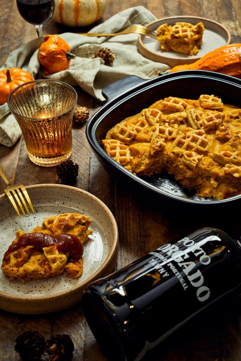 Trader Joe's Pumpkin Waffle Bread Pudding Recipe | Trader Joe's Fall Recipe Ideas | Trader Joe's Wine by popular D.C. lifestyle blogger, Alicia Tenise: image of pumpkin waffle bread pudding, mini pumpkins, cloth napkins, candle votive, and a bottle of red wine.