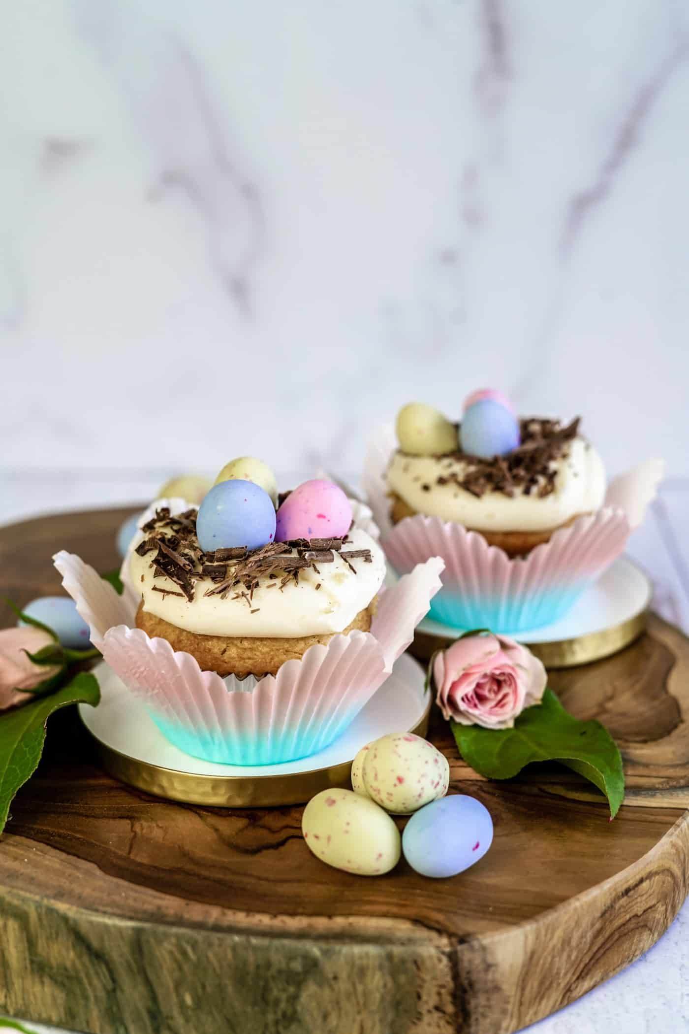 Two Easter Egg Cupcakes topped with chocolate and easter eggs