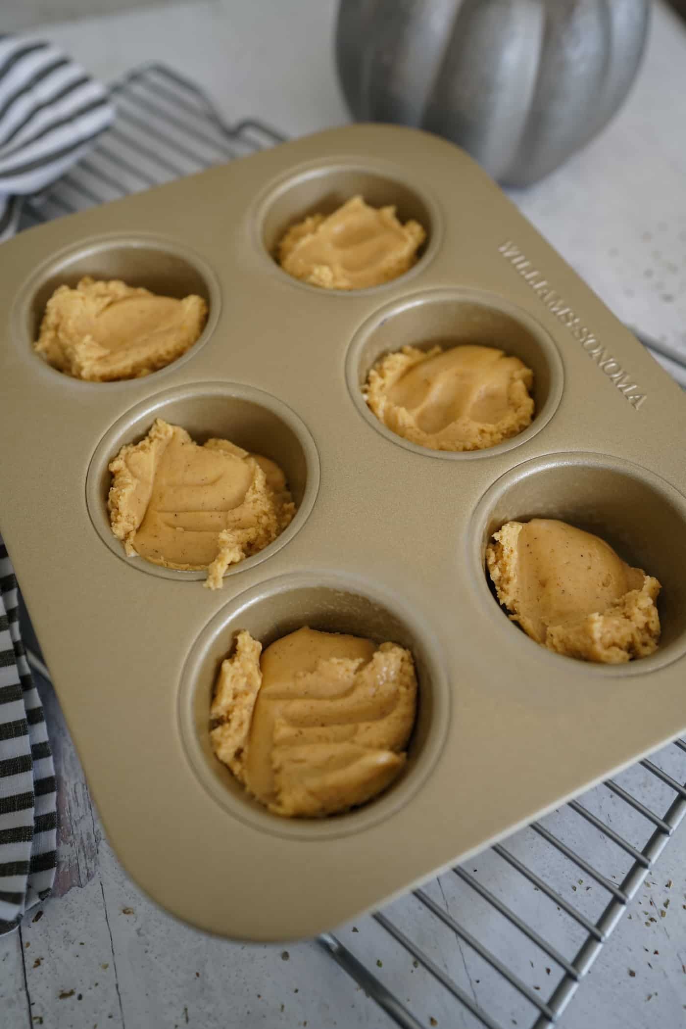 Muffin tin filled with pumpkin spice cookie dough