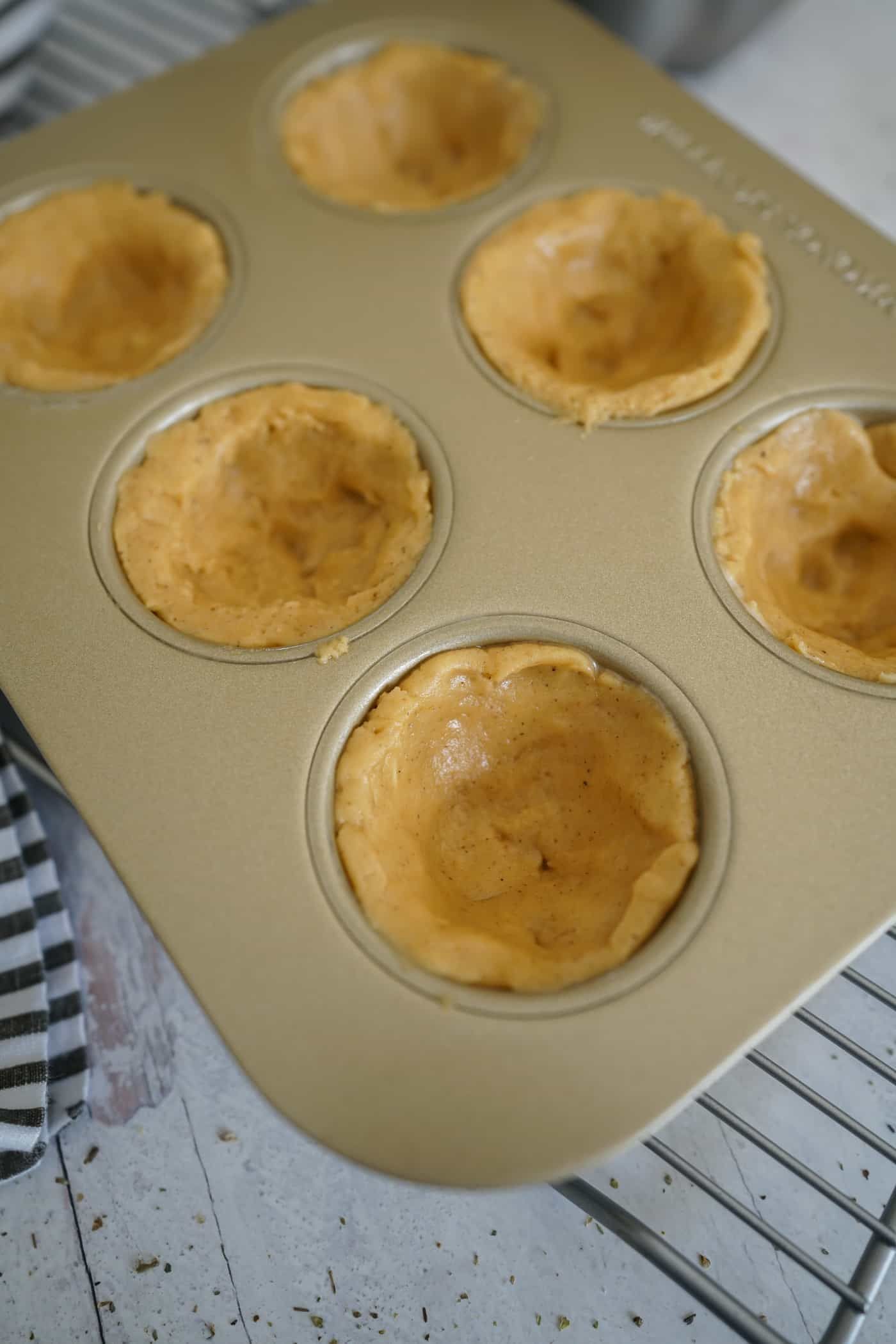 Muffin tin filled with pumpkin spice cookie dough cups