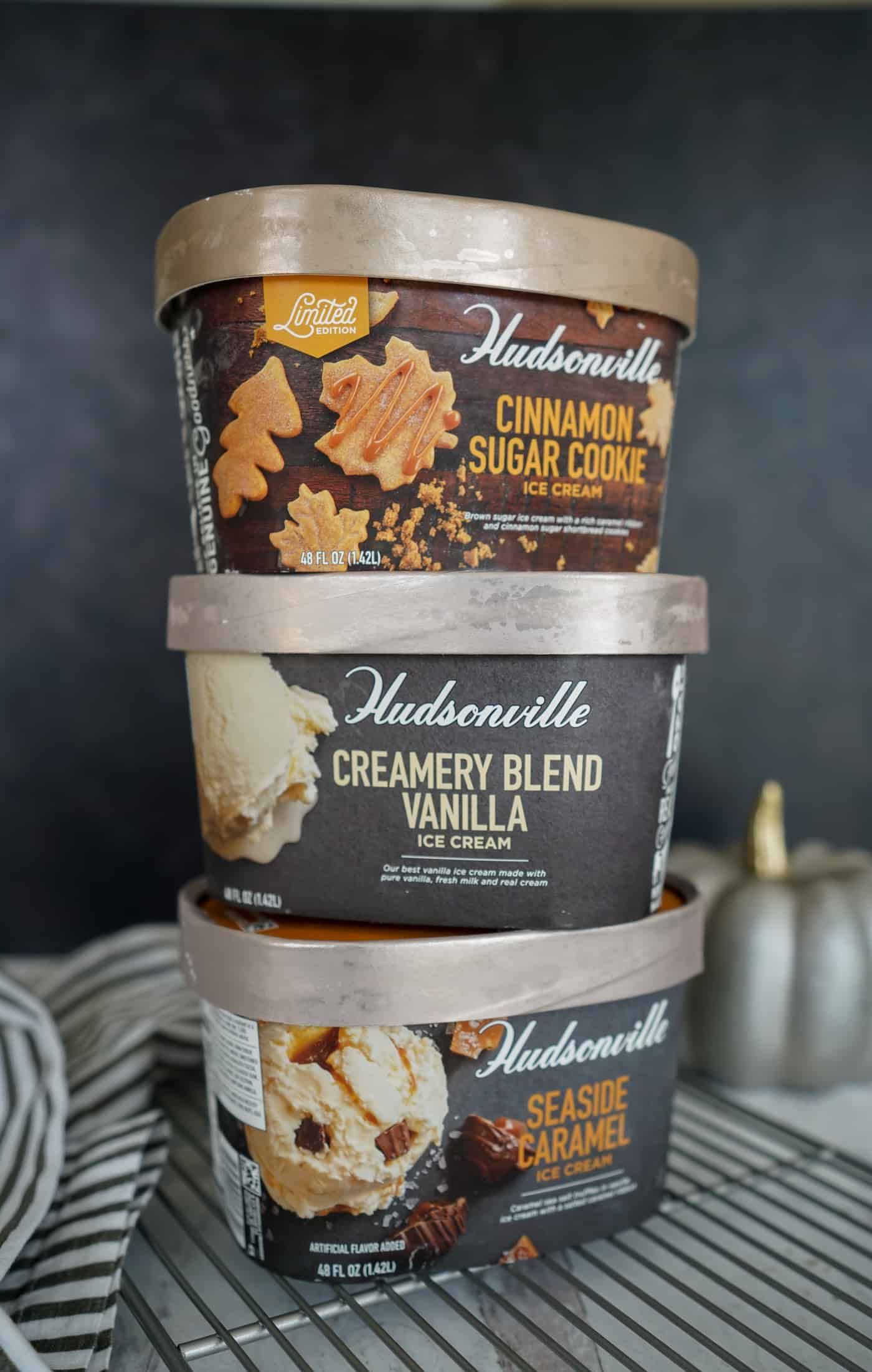 A tall stack of one gallon containers of Hudsonville ice cream
