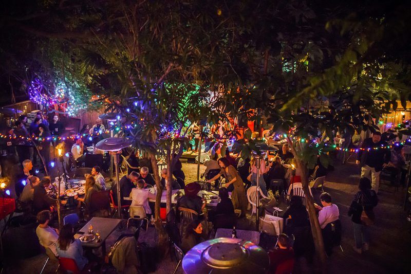 Top Things to Do in Bywater New Orleans featured by top US travel blogger, Alicia Tenise: have dinner at Bacchanal Wine New Orleans