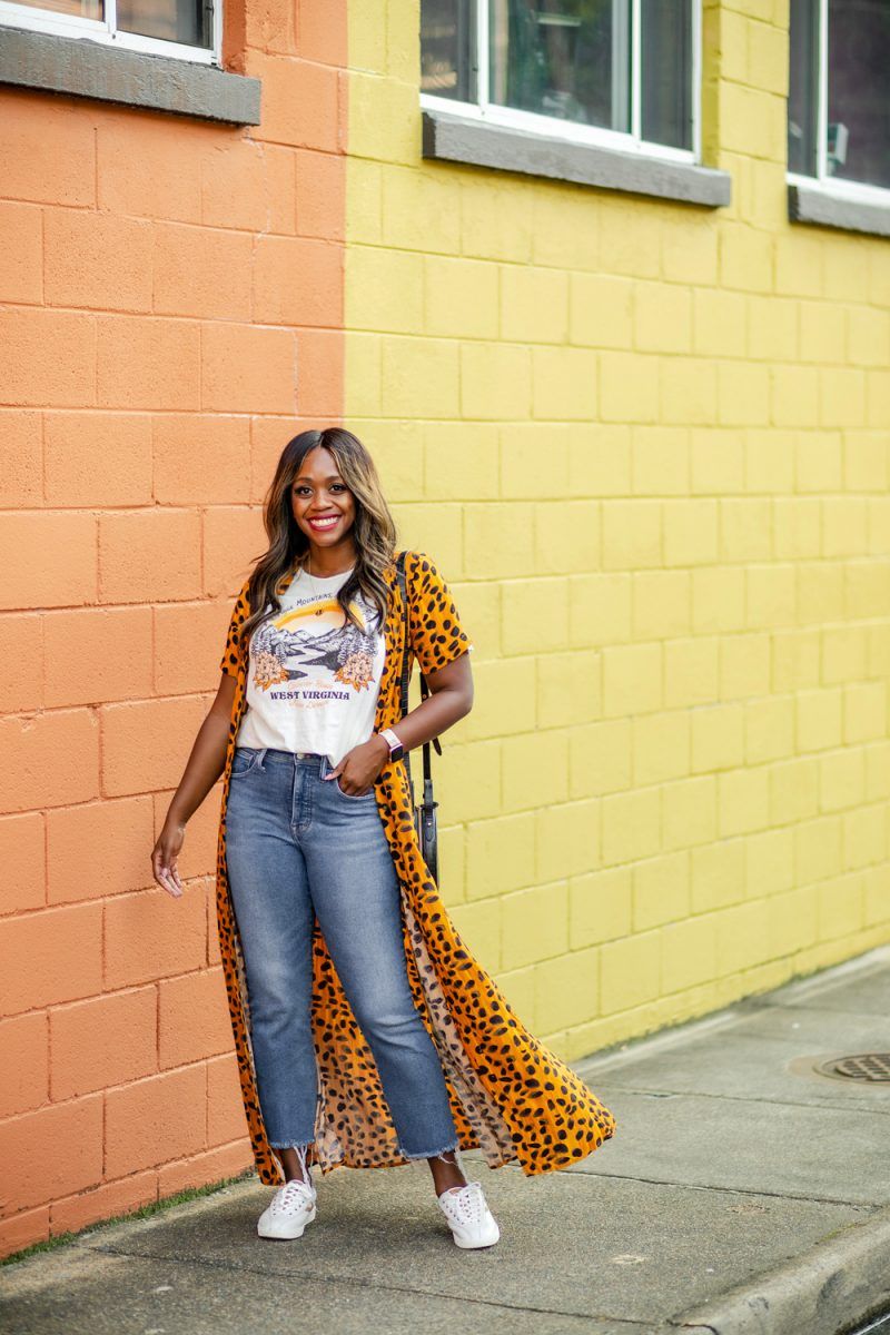 Vianne Maxi Shirtdress, Blue Ridge Mountains Graphic Tee, Madewell Cali Boot Denim | Leopard Print Shirt Dress by popular D.C. fashion blogger, Alicia Tenise: image of Alicia Tenise walking outside next to a peach colored building and wearing a Anthropologie leopard print shirt dress, Anthropologie Blue Ridge Mountains Graphic Tee, Madewell Cali Demi-Boot Jeans in Timpson Wash, Macy's adidas Originals Sleek Casual Sneakers from Finish Line, and Sparkel SKINNY BAND IN UPCYCLED LV DAMIER AZUR.