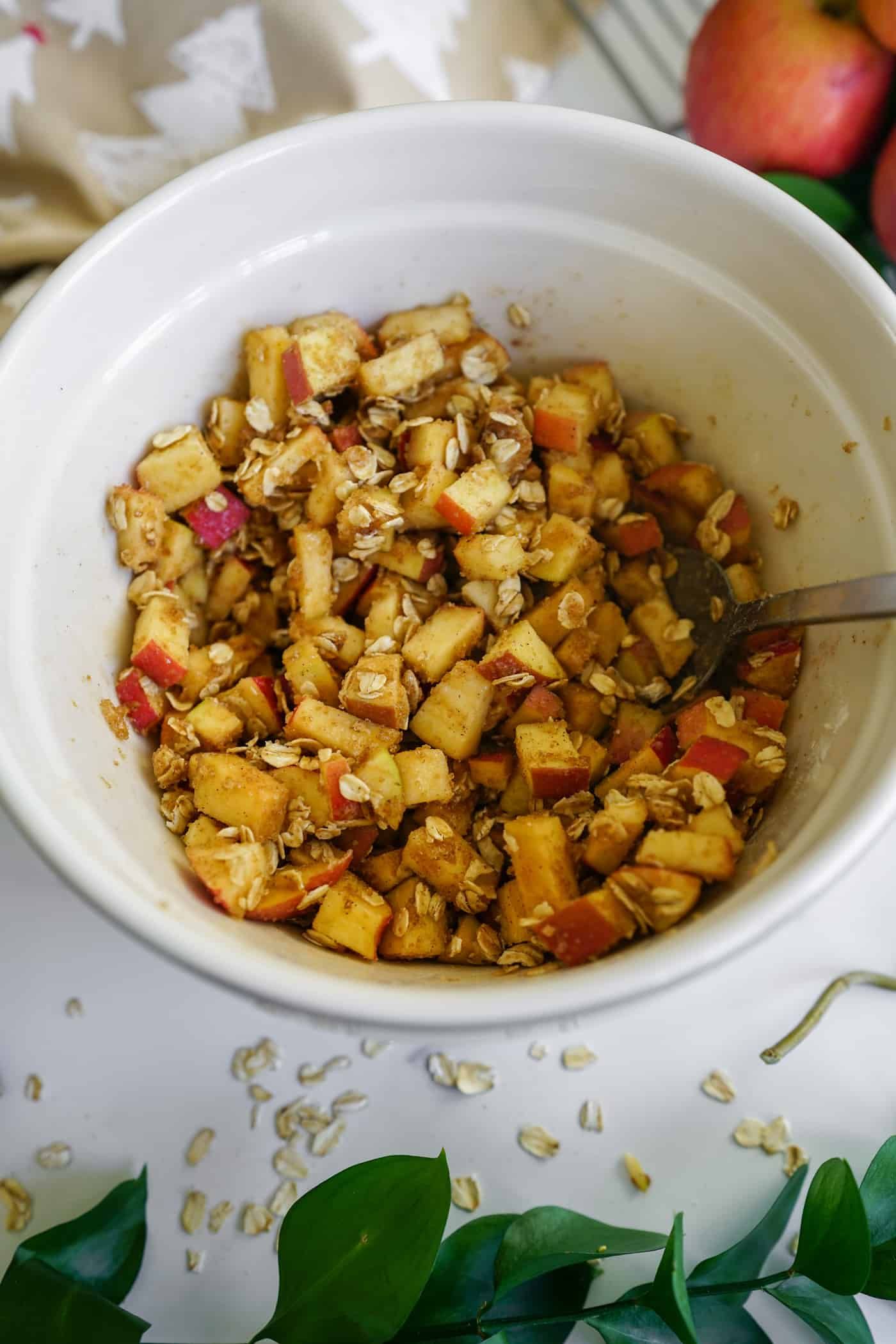 A large mixing bowl filled with an apple crisp mix