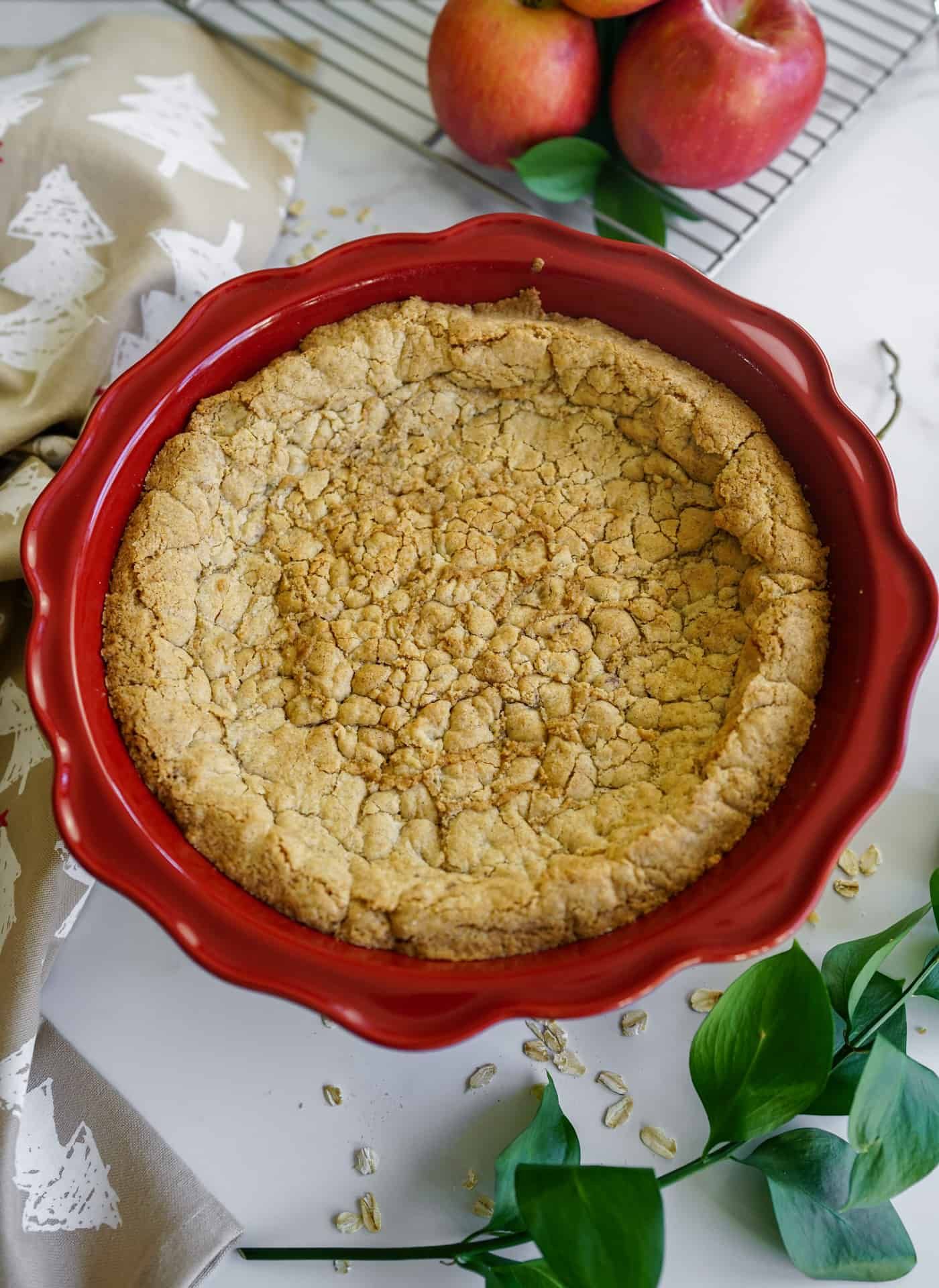 A red 9 inch pie pan filled with cooked pie crust