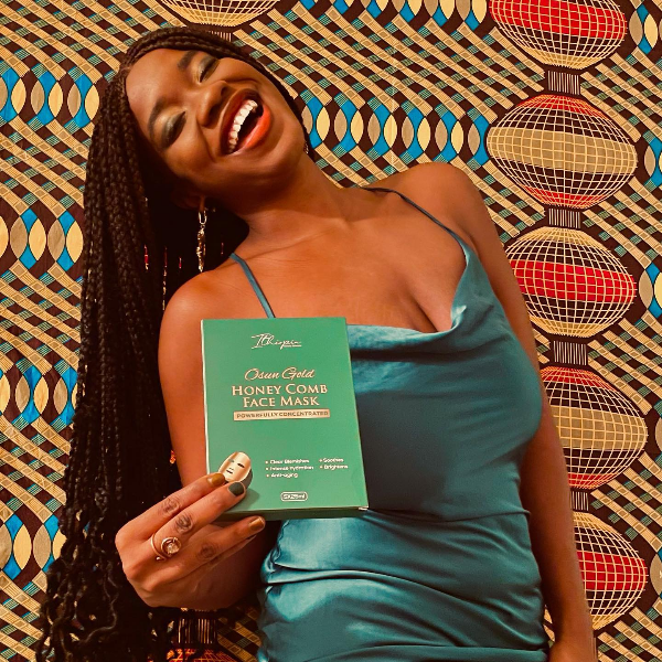 Black woman holding sheet mask