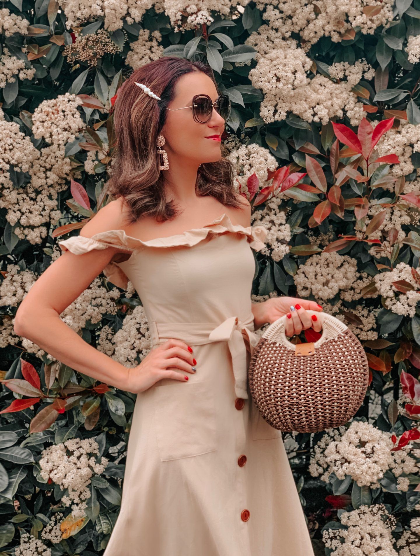 OUTFIT FROM ELEGANT DUCHESS BOUTIQUE Round Summer Beach Straw Bag | Off shoulder ruffle detail midi dress | TEXTURED GEOMETRIC EARRINGS | Pearl Hair Clip | MIU MIU SUNGLASSES