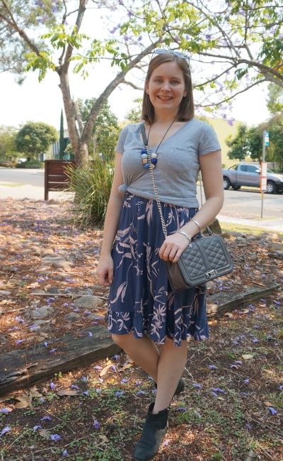 grey v neck tee knotted over printed tiered sundress with ankle boots love bag | away from blue
