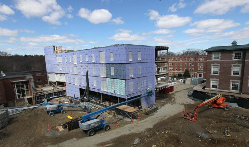 Regis College’s renovations include an extension of Maria Hall (center), which will look onto a grassy quad that is replacing a parking lot.